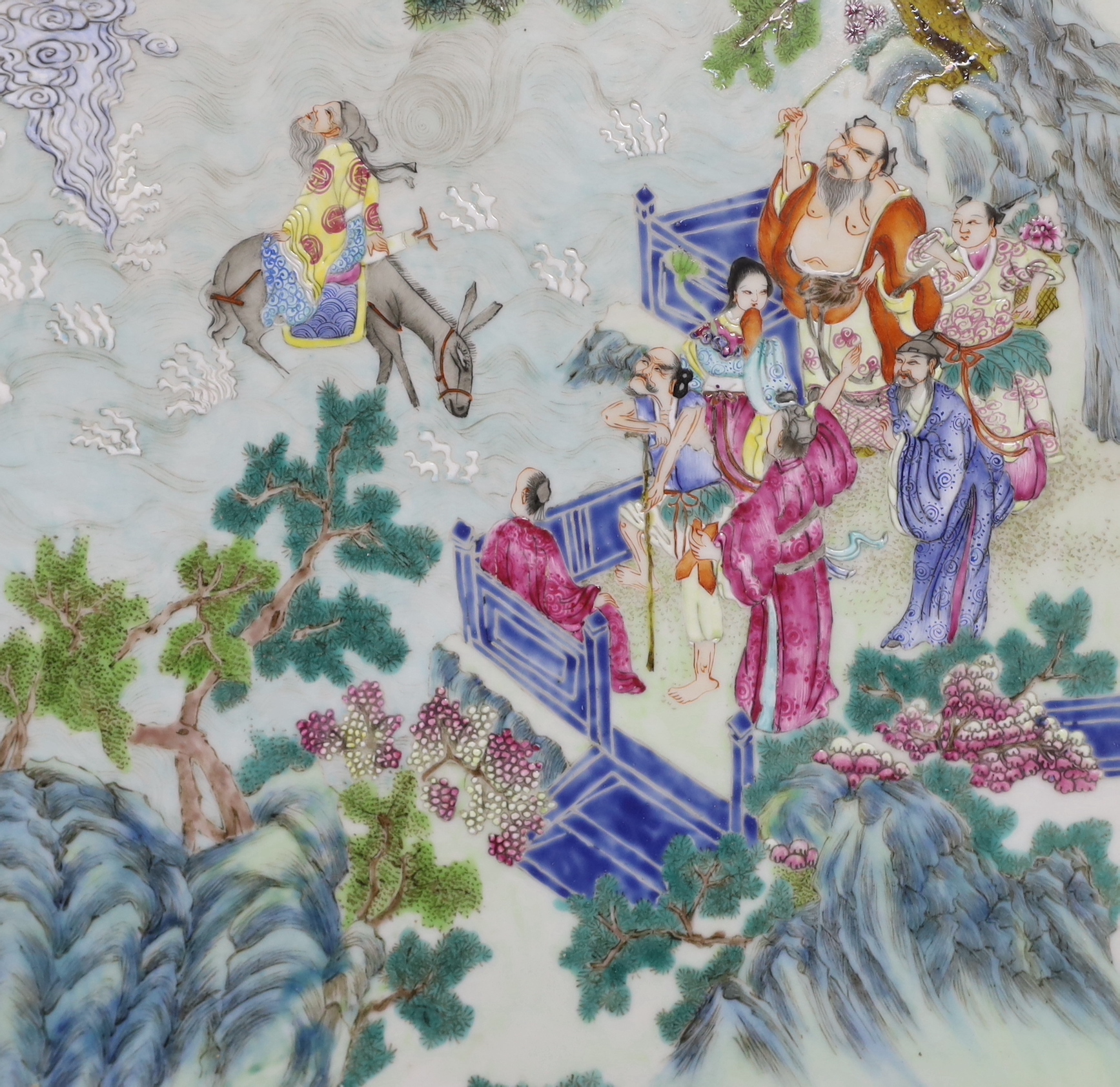 A Chinese enamelled porcelain plaque, decorated with immortals and pagodas in a landscape, framed, overall 47cm x 32cm